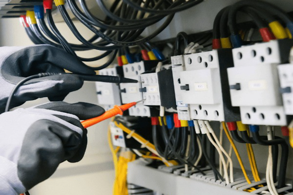 Professional electrician testing electrical panel