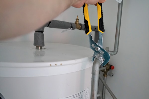 Plumber servicing a residential water heater